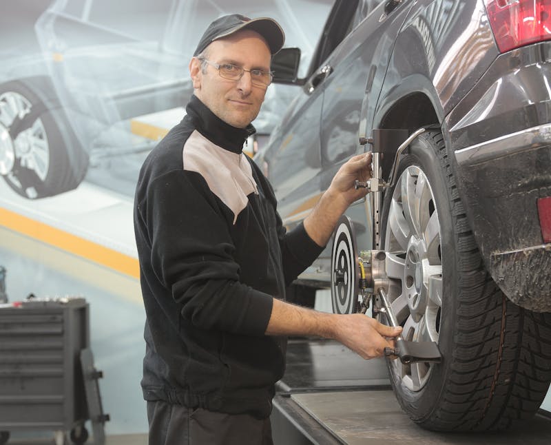 Mechanic inspecting a used car engine before purchase